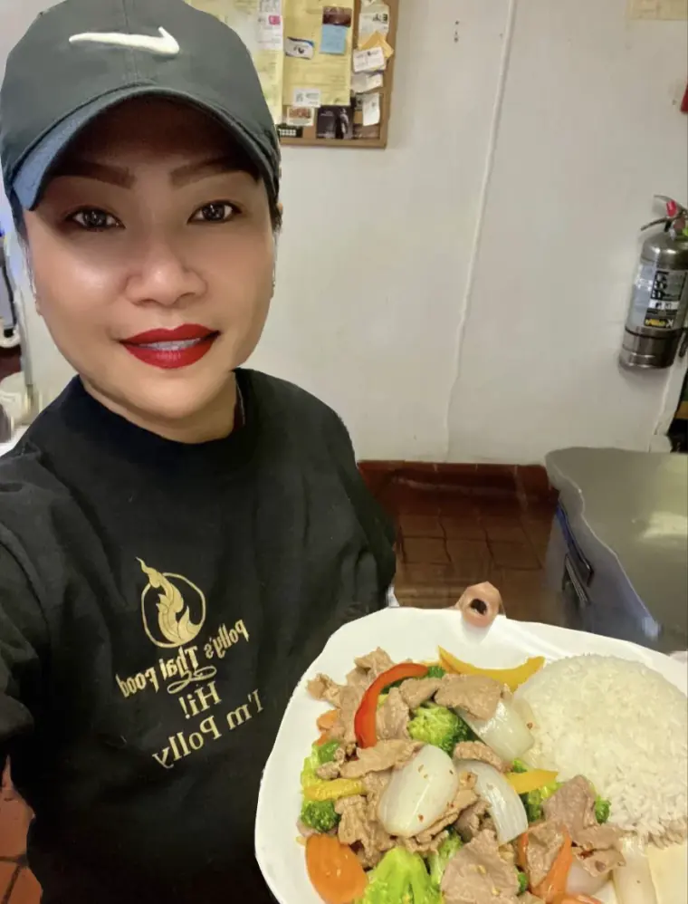 Polly holding a fresh plate of stir-fry with jasmine rice at Polly's Thai Food in Lawton, OK
